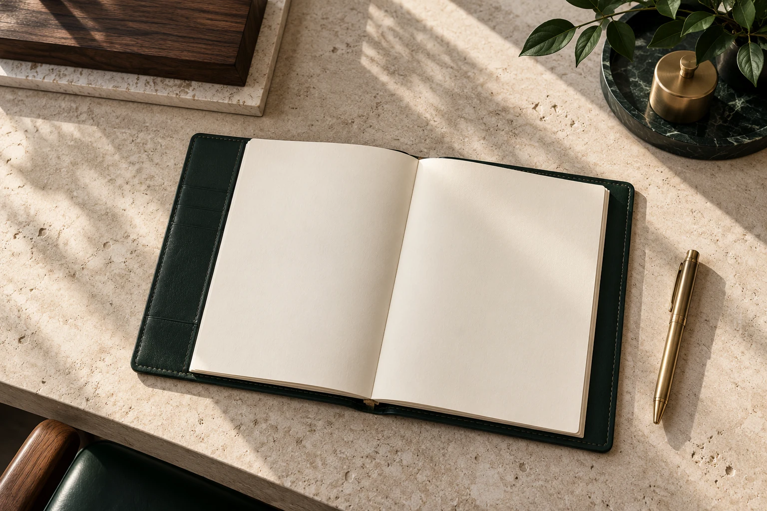 Open notebook and brass pen on a stone desk.